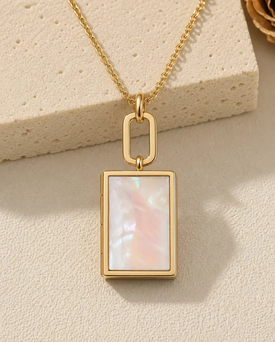 Gold book shaped photo locket necklace with a mother of pearl front