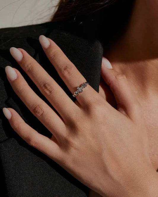 Cross Moissanite Ring in 925 Sterling Silver - worn on a hand resting on the shoulder
