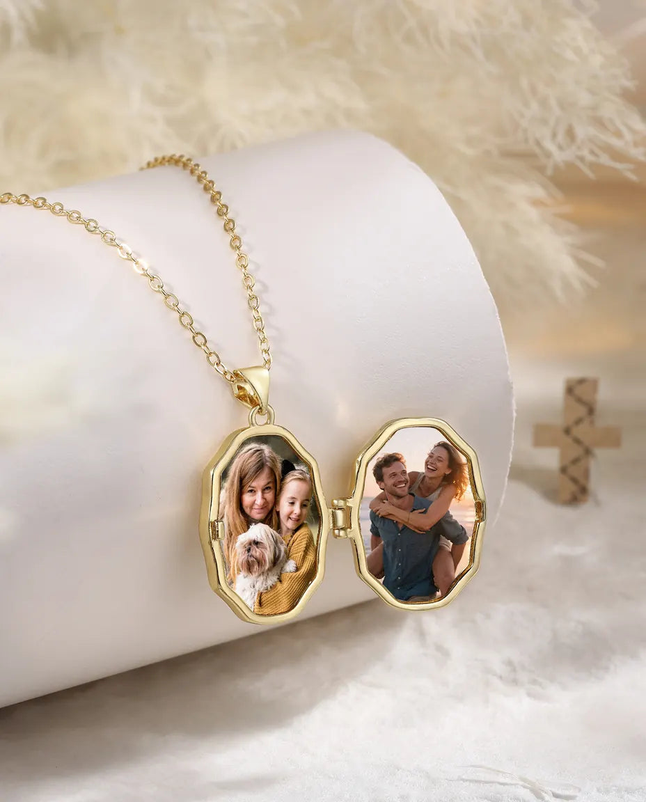 Gold cross photo locket necklace open showing two family photos inside