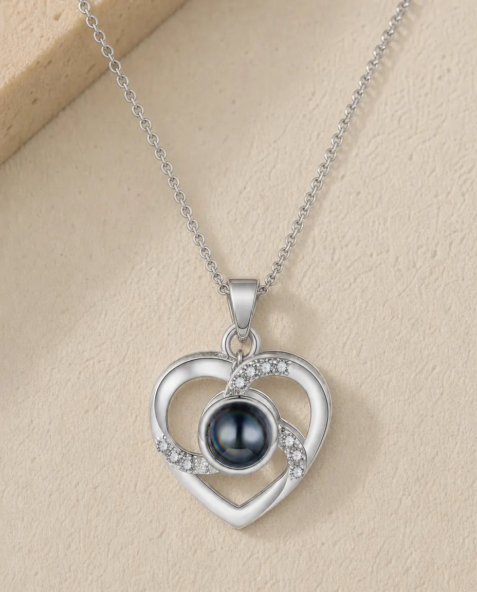Personalized crystal heart photo projection necklace in silver, flat lay