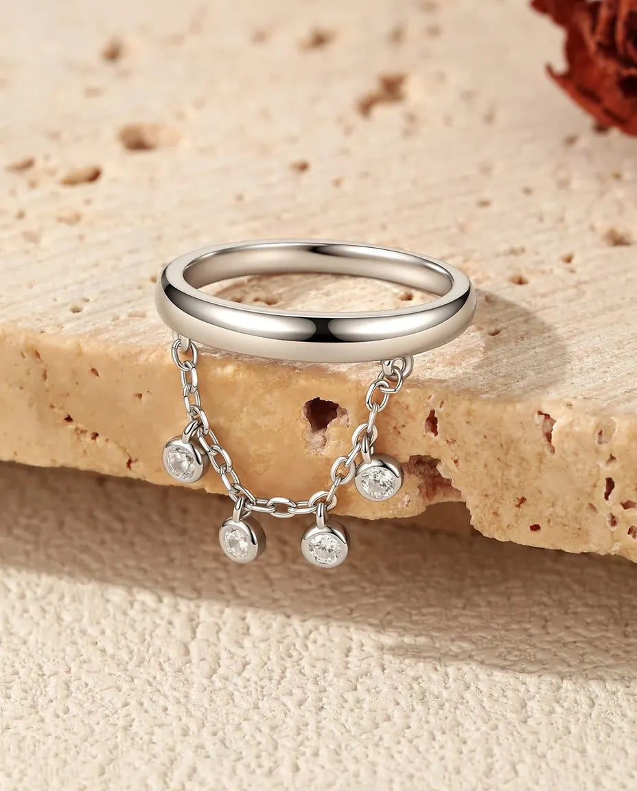 Sterling silver charm ring with draped chain and bezel set cubic zirconia drops