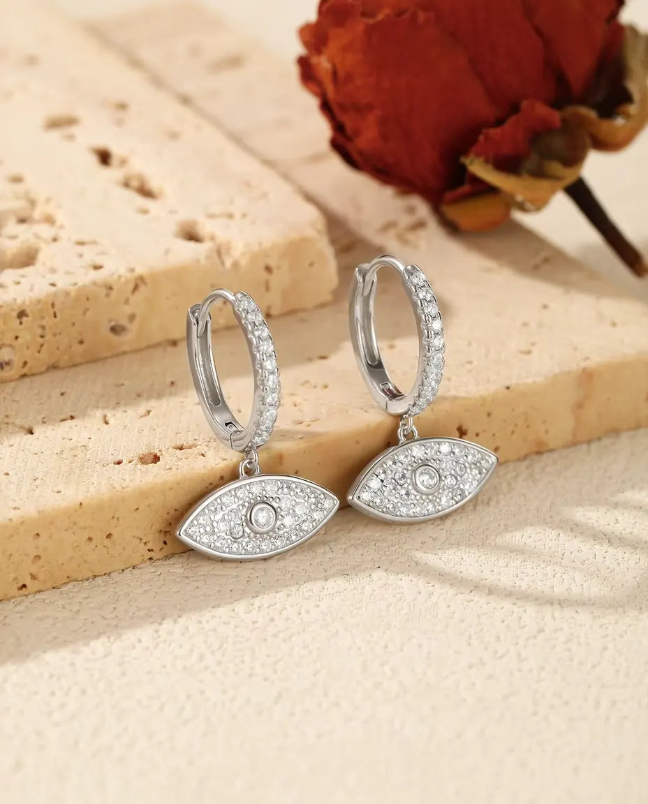 Evil Eye Drop Earrings in 925 Sterling Silver - the pair on a cream stone surface