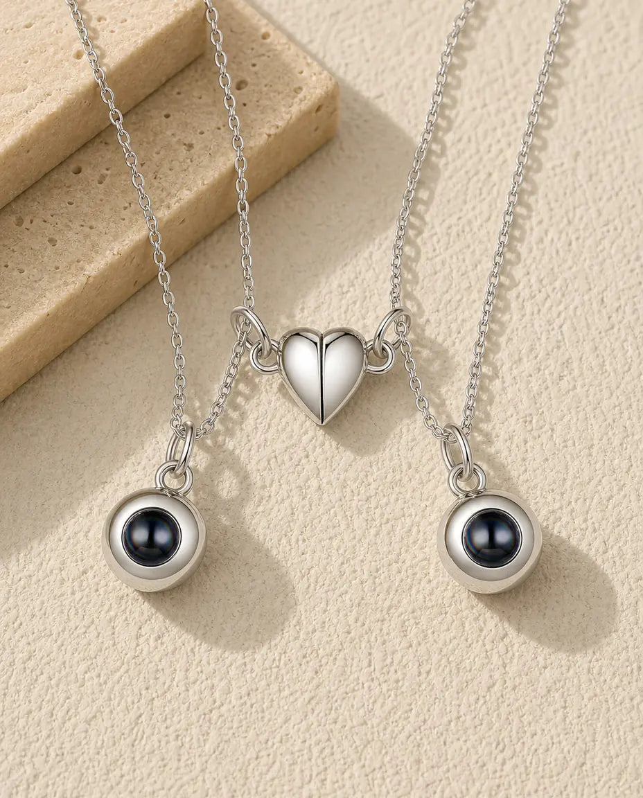Personalized magnetic half heart photo projection couple necklace set of two in silver, flat lay