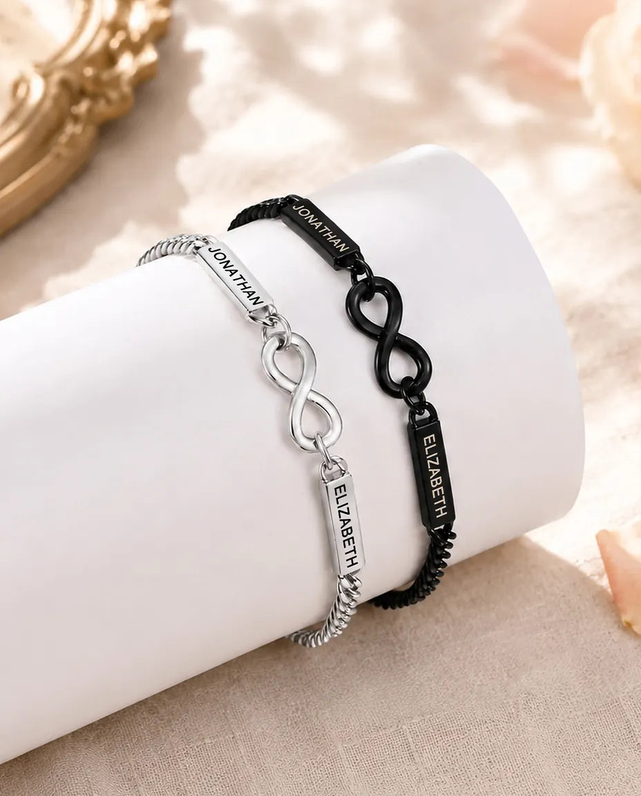 Personalized Infinity Couple Bracelets With 2 Engraved Names - Matching Silver & Black Name Bar Bracelet Set - matching pair styled on a display stand