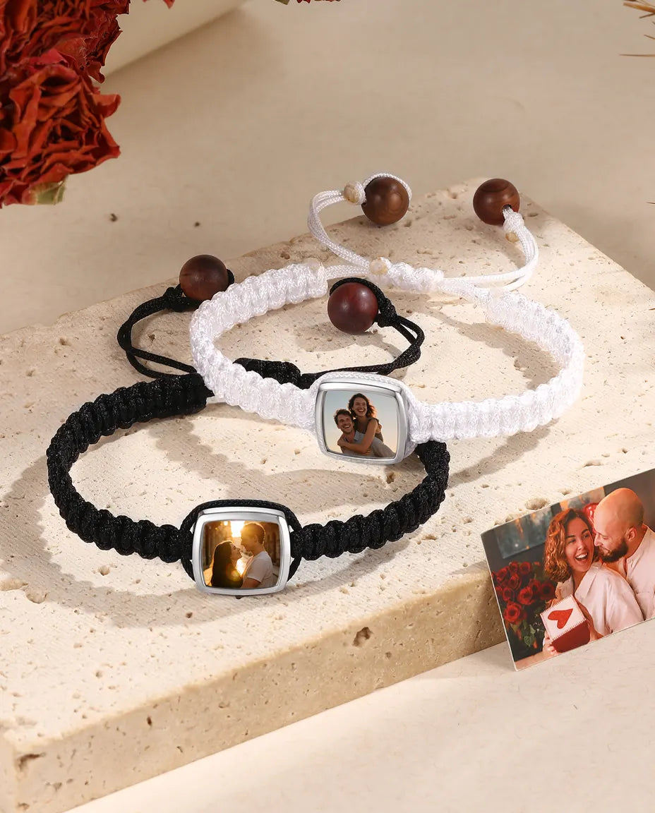 Matching black and white braided couple bracelets with square photo charms and photo card