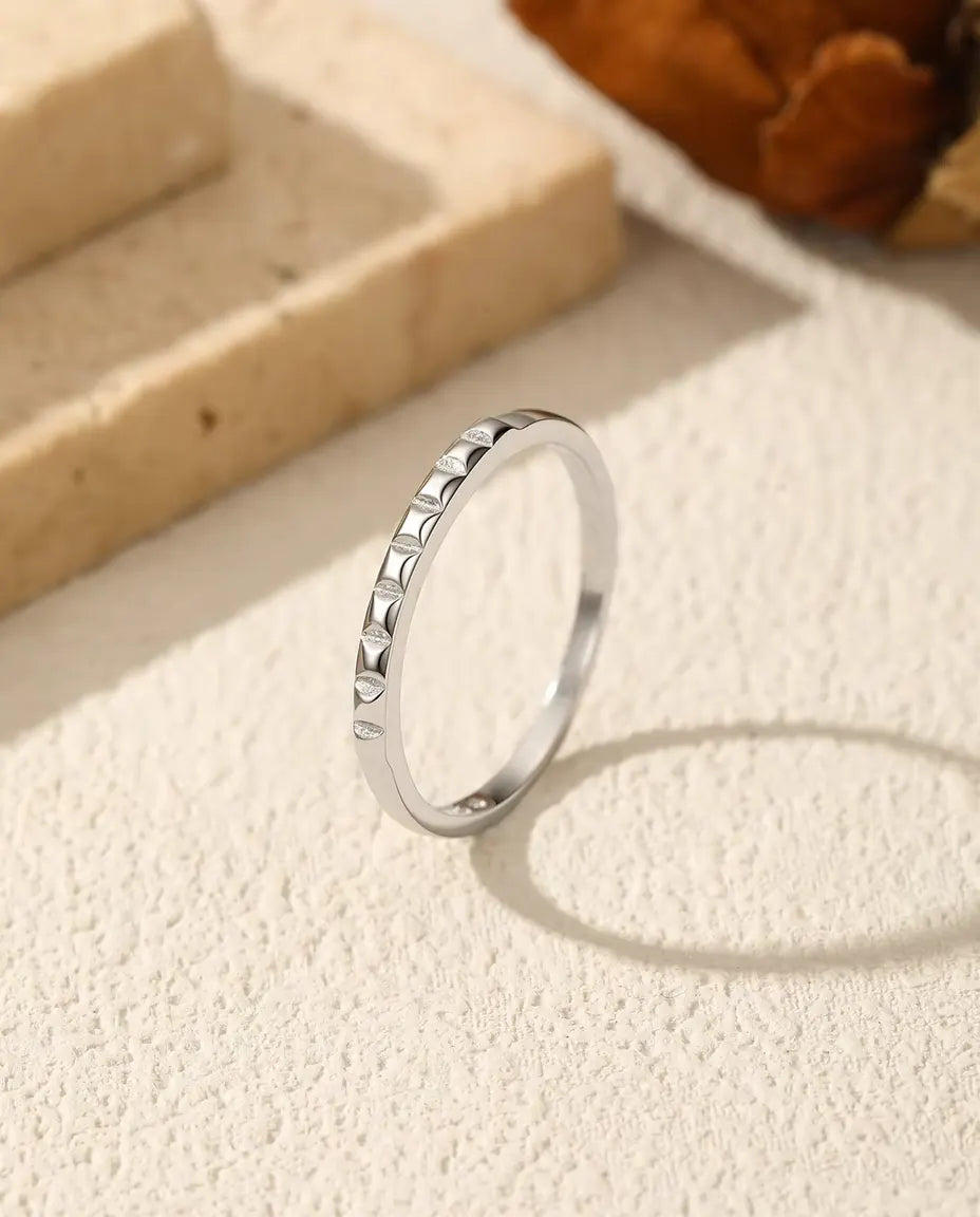 Studded Stacking Ring in 925 Sterling Silver - standing upright on a cream textured surface