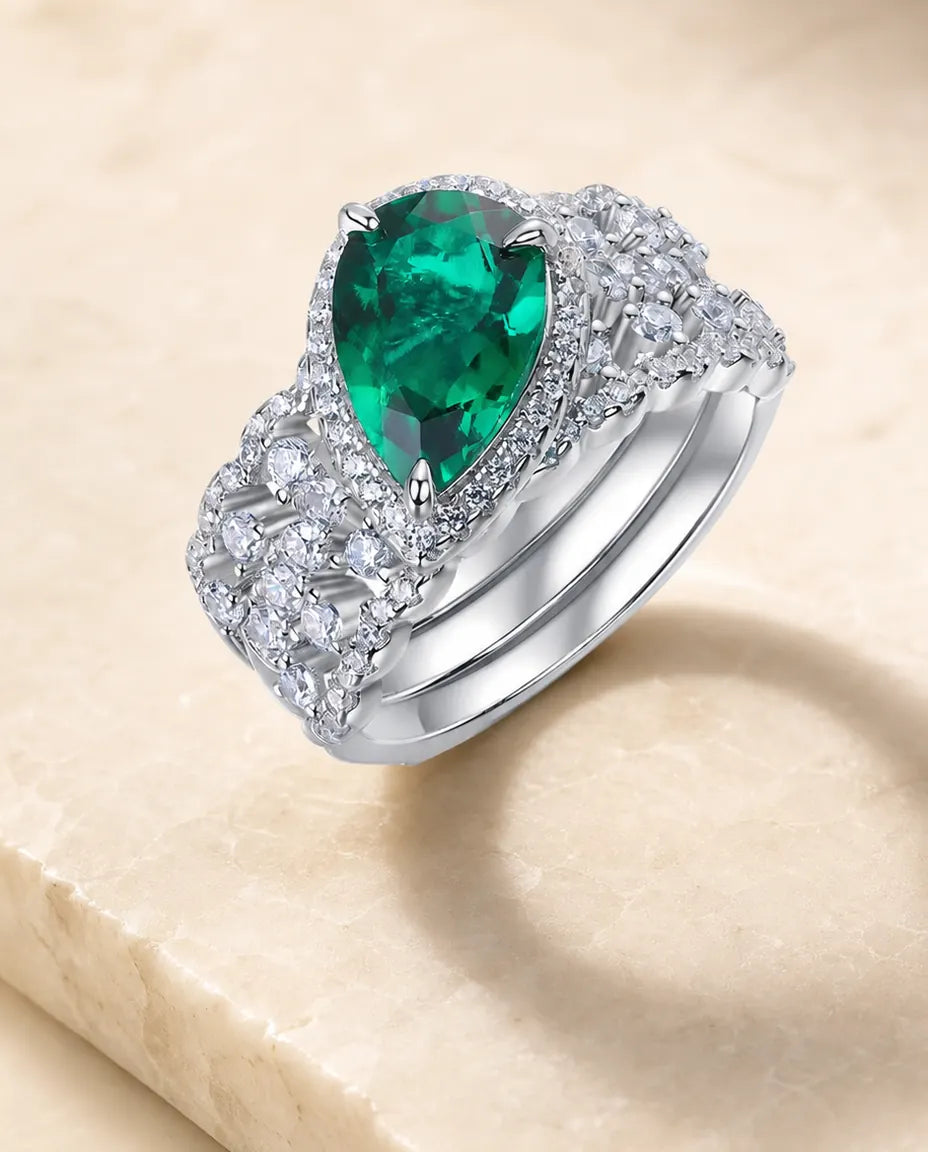 lab-created emerald pear-cut 2-piece halo bridal set ring in sterling silver