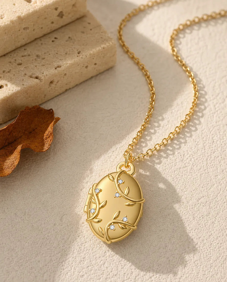 Personalized vine and crystal oval photo locket necklace holding two pictures, gold