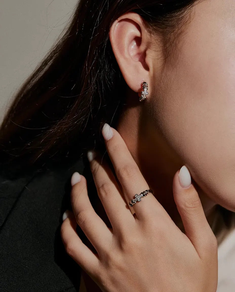 Cross Moissanite Ring in 925 Sterling Silver - worn on a model with her hands near her face