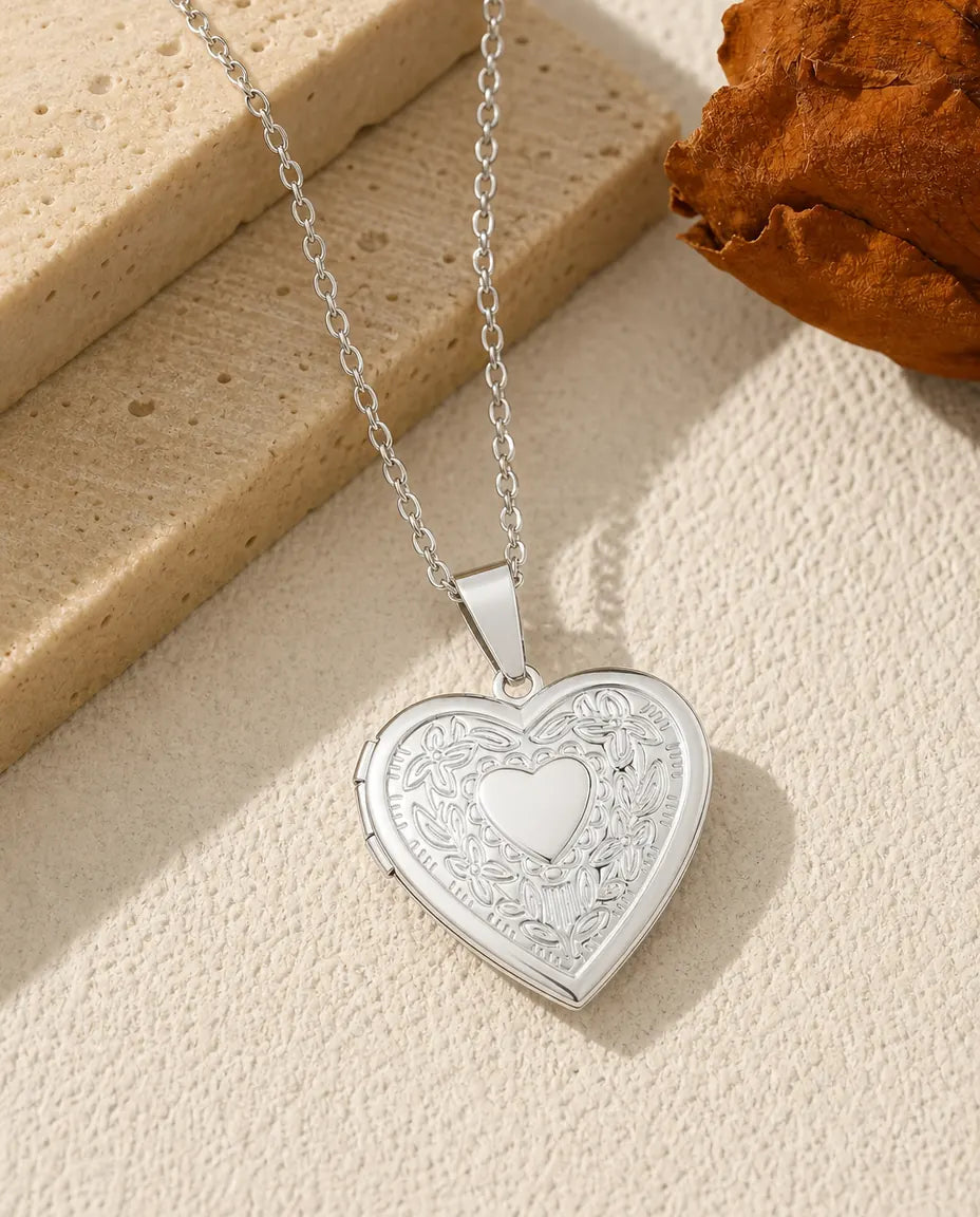 Floral heart photo locket necklace in polished silver with embossed blossom wreath front
