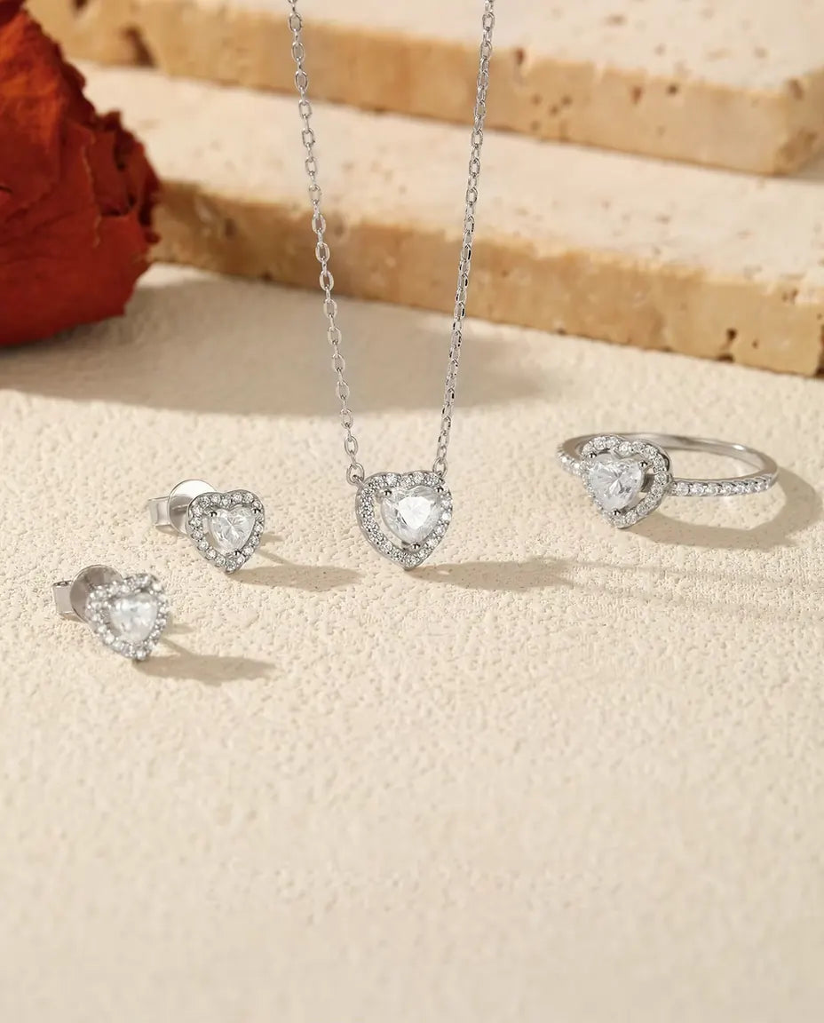 Heart Moissanite Jewelry Set in 925 Sterling Silver - the full set on a cream stone surface