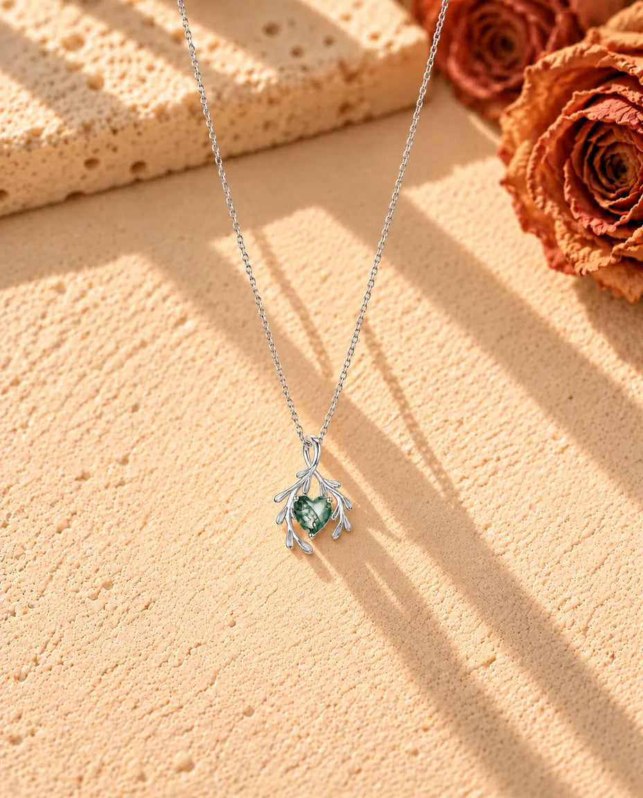 Heart Moss Agate Branch Necklace in 925 Sterling Silver - the whole necklace laid out in a long V on a cream textured surface
