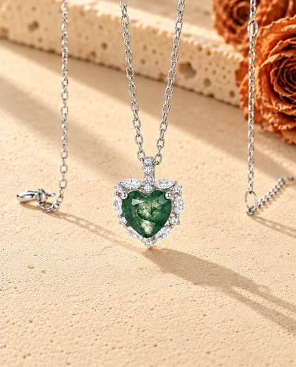 Heart Moss Agate Halo Necklace in 925 Sterling Silver - seen at an angle on a cream textured surface