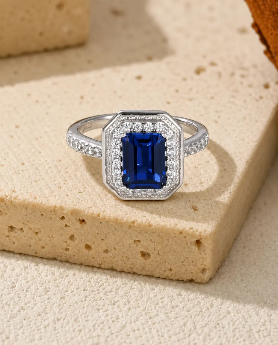 Lab sapphire octagon halo ring in sterling silver with milgrain frame and pave band