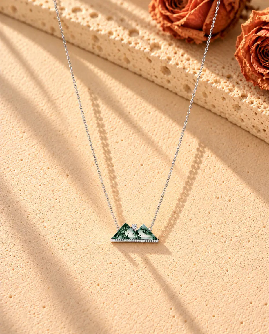 Mountain Moss Agate Necklace in 925 Sterling Silver - the whole necklace laid out in a long V on a cream textured surface