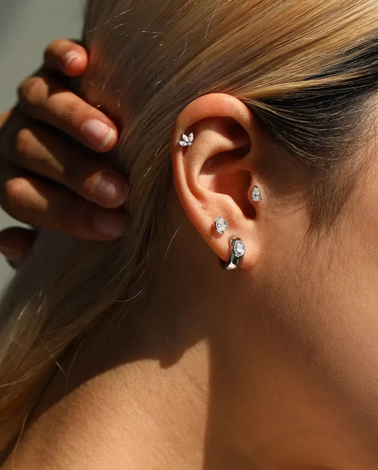 Oval Moissanite Stud Earrings in 925 Sterling Silver - worn on a model with her hand at the back of her head