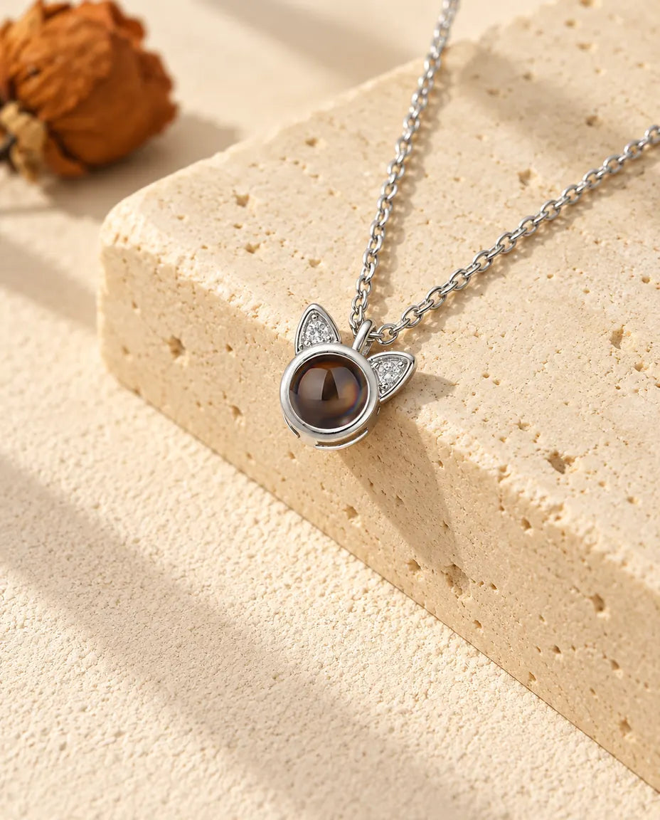 Silver tone cat ear projection necklace with cubic zirconia ears