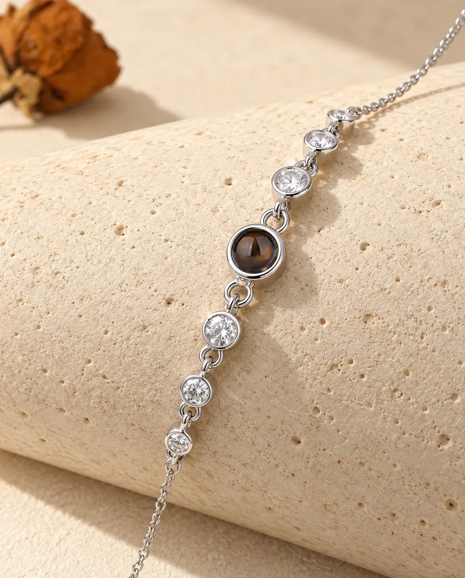 Close-up of the silver tone stone row with its brown projection stone on a travertine block