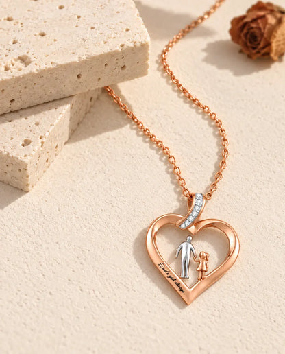Dad and daughter heart pendant with a cubic zirconia ribbon bail, shown at an angle on plaster