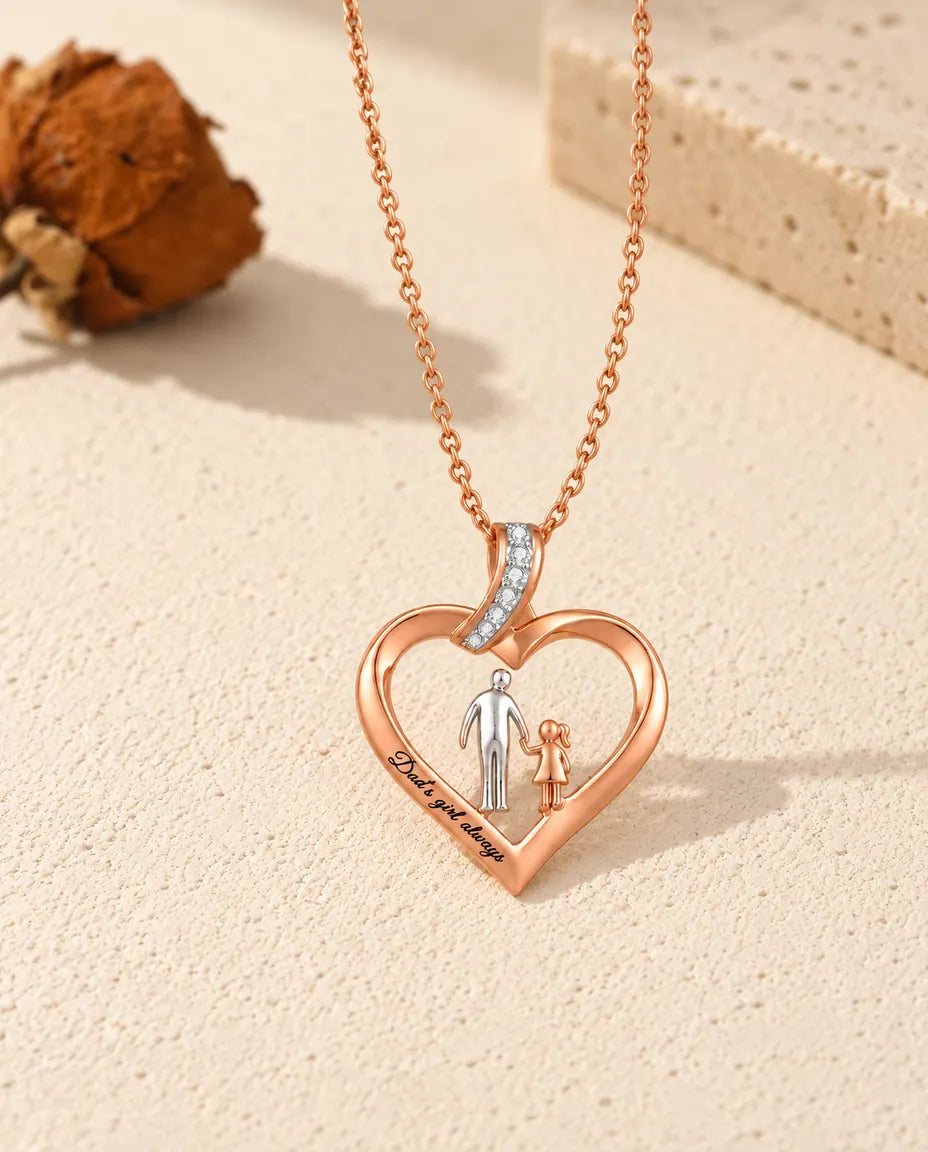 Custom engraved dad's girl heart necklace laid flat with its rose gold-tone chain