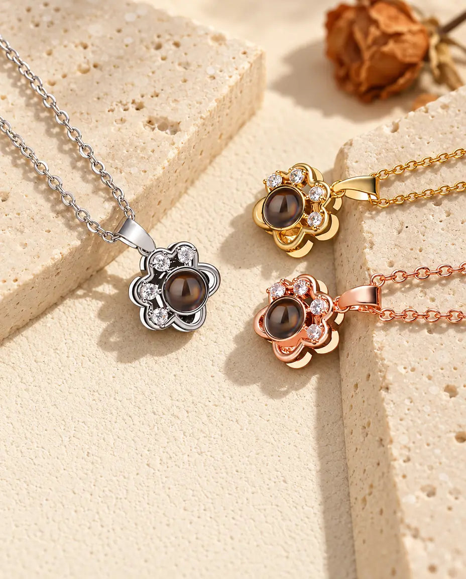 Silver tone, gold tone and rose gold tone paw print pendants with cubic zirconia toes