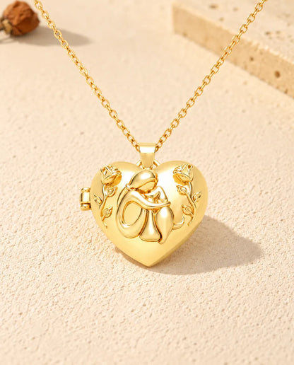Front view of the gold tone heart locket: a woman hugging her dog, roses on each side and the side hinge