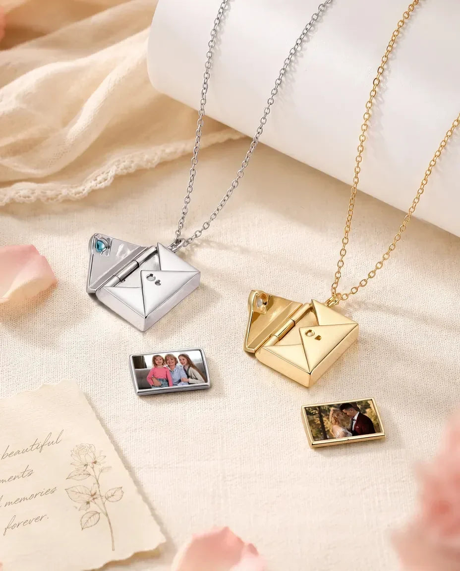 Personalized envelope photo locket necklaces in silver and gold, opened with slide-out photo cards and heart birthstones