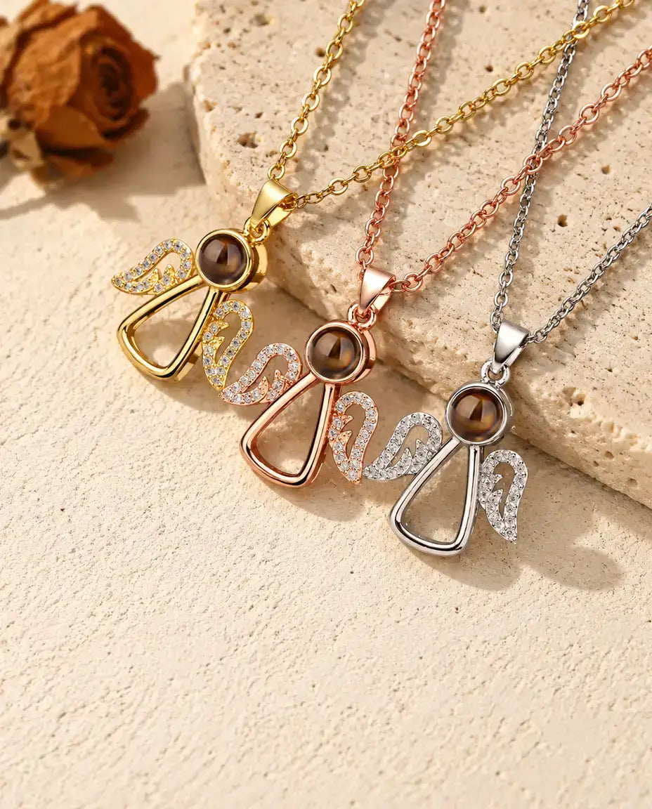 Gold tone, rose gold tone and silver tone angel pendants in a row