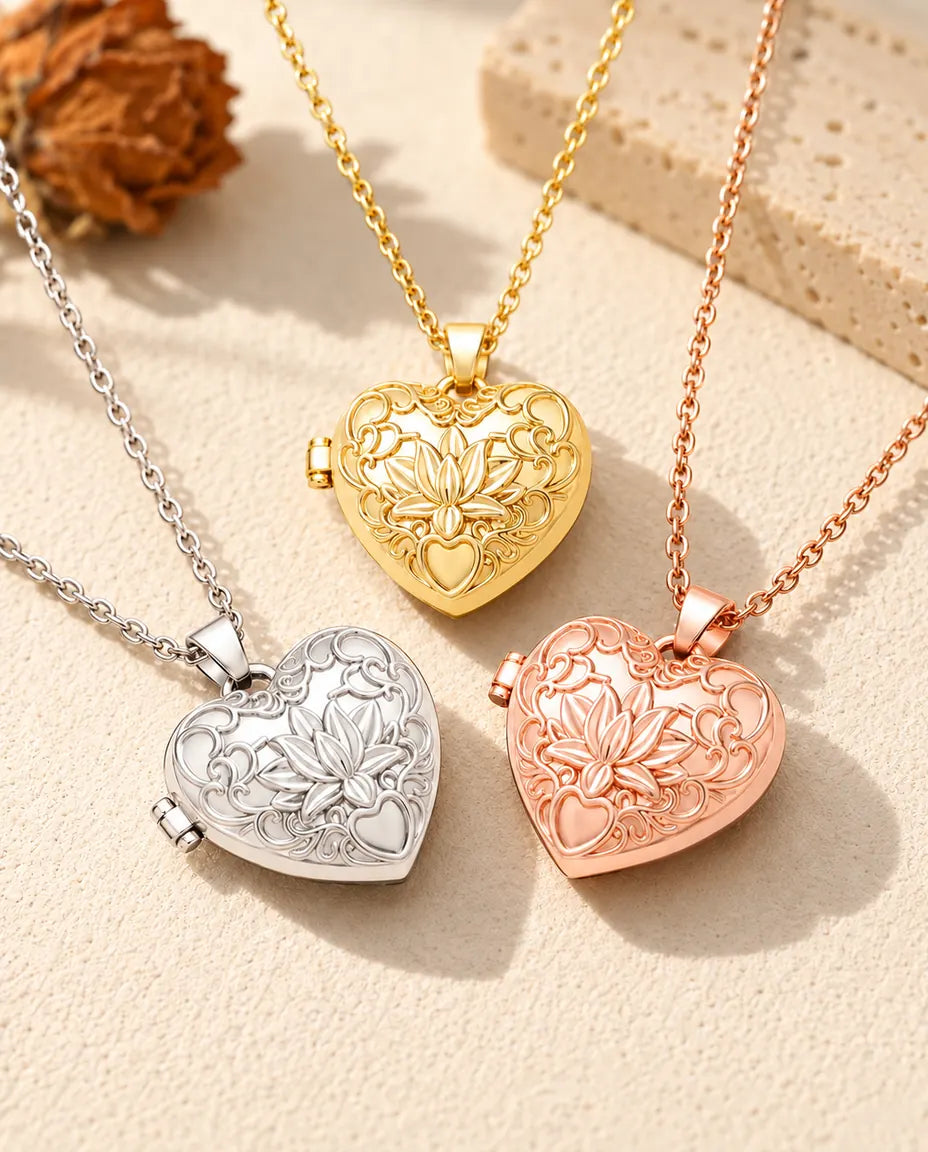 Three colors of the lotus flower heart photo locket necklace arranged on plaster