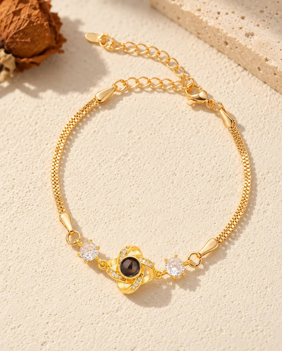 Top view of the gold tone love knot photo projection bracelet