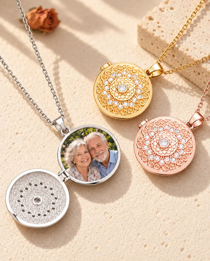 Silver tone mandala flower photo locket opened to show a grandparents photo inside, beside closed gold tone and rose gold tone lockets