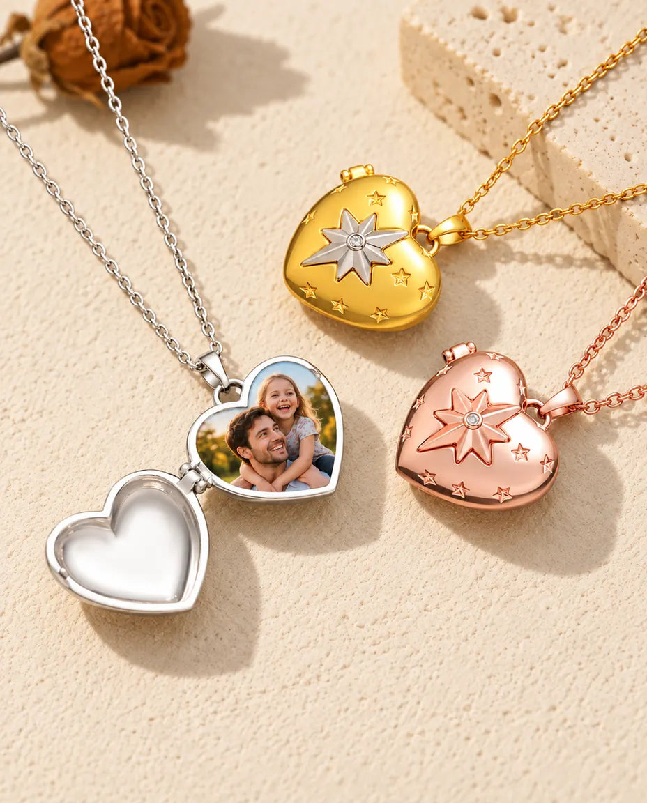 Silver tone north star heart photo locket opened to show a father and daughter photo inside, beside closed gold tone and rose gold tone lockets