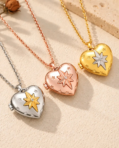 North star heart photo lockets in silver tone, rose gold tone and gold tone laid diagonally on cream plaster