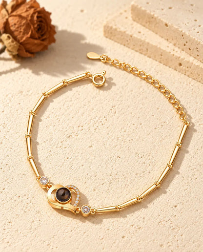 Gold tone open heart bracelet with a pave line, side stones and spring ring clasp