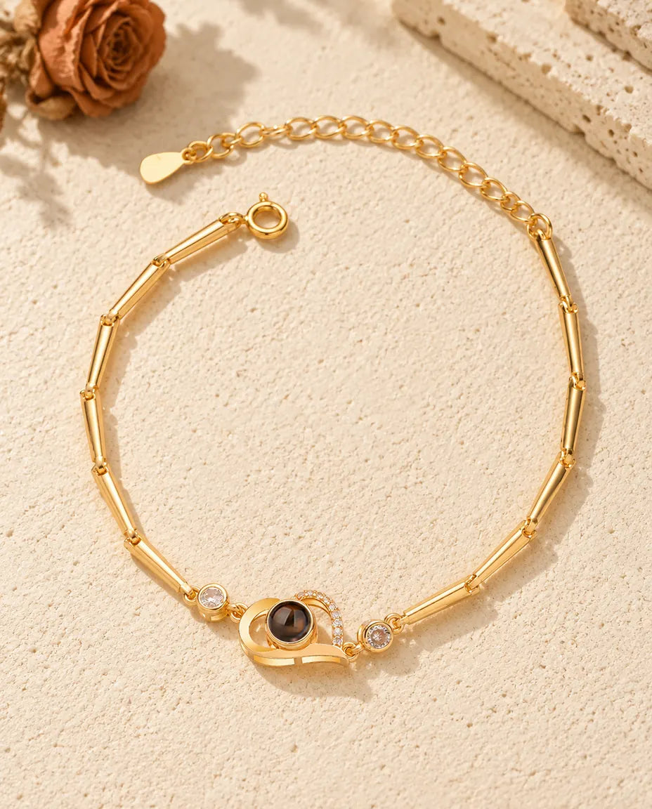 Top view of the gold tone open heart photo projection bracelet