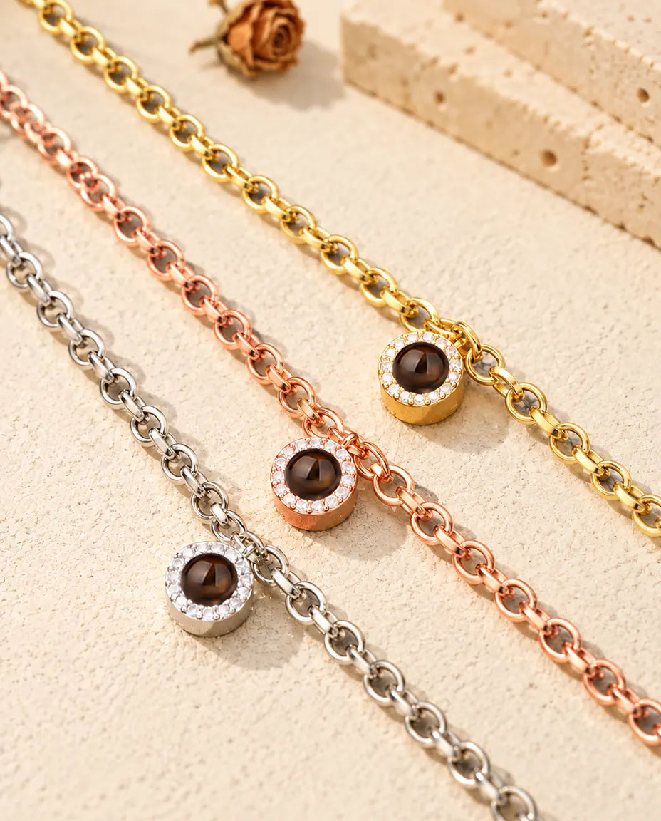 Close-up of three pave circle projection bracelets in gold tone, rose gold tone and silver tone