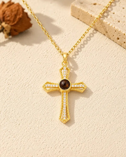 Front view of the gold tone pave cross photo projection necklace