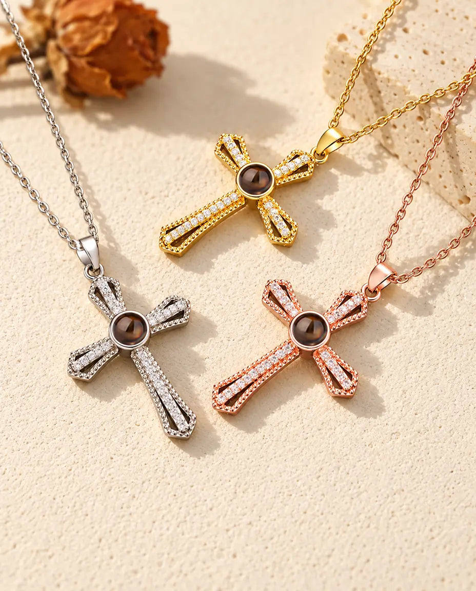Silver tone, gold tone and rose gold tone crosses with brown projection stones arranged by a travertine slab
