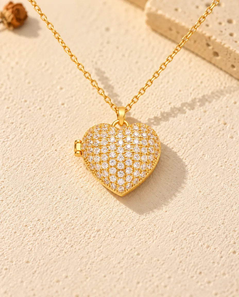 Front view of the gold tone pave heart photo locket showing the lid design and side hinge