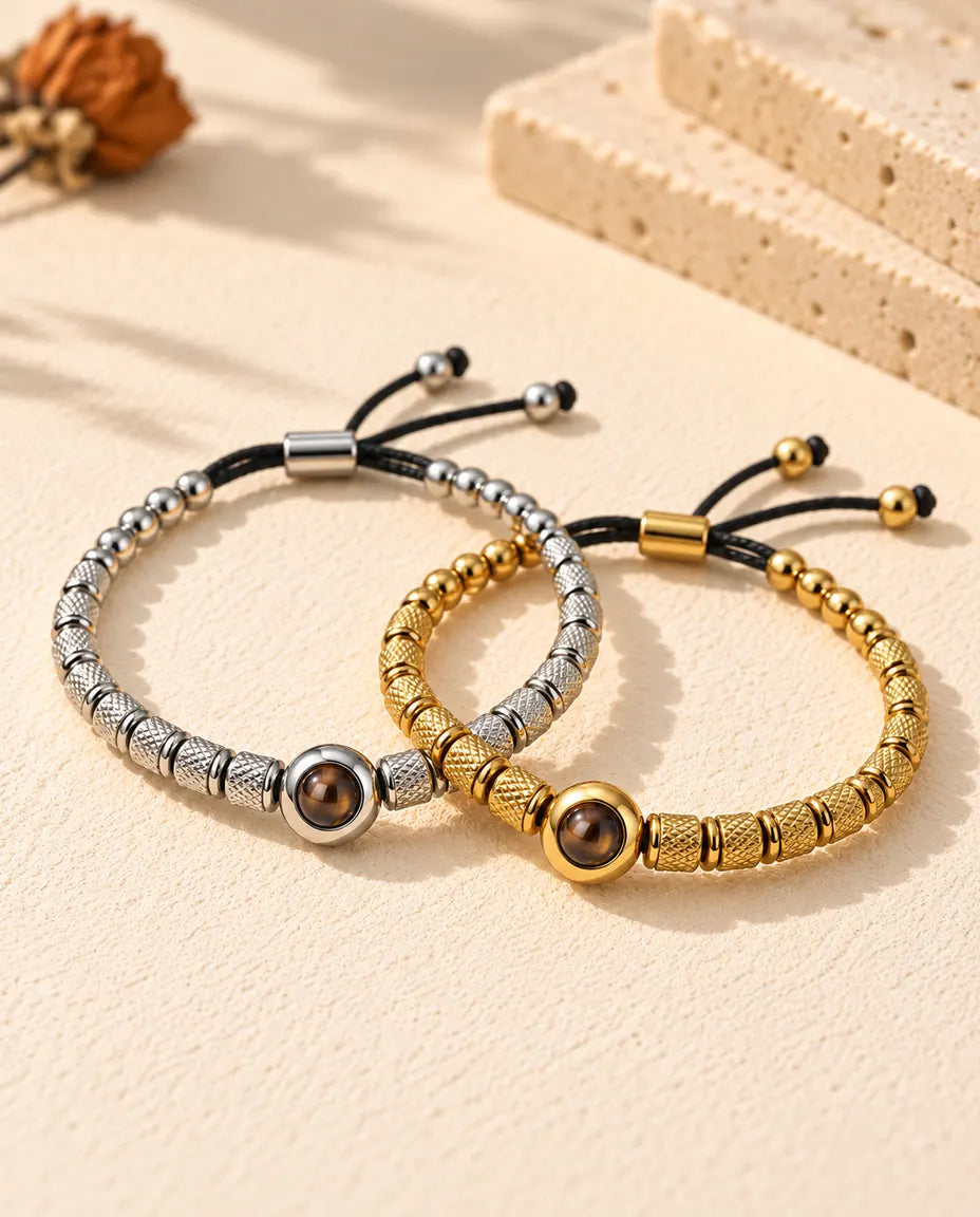 Silver tone and gold tone projection bead bracelets linked together like two rings on plaster
