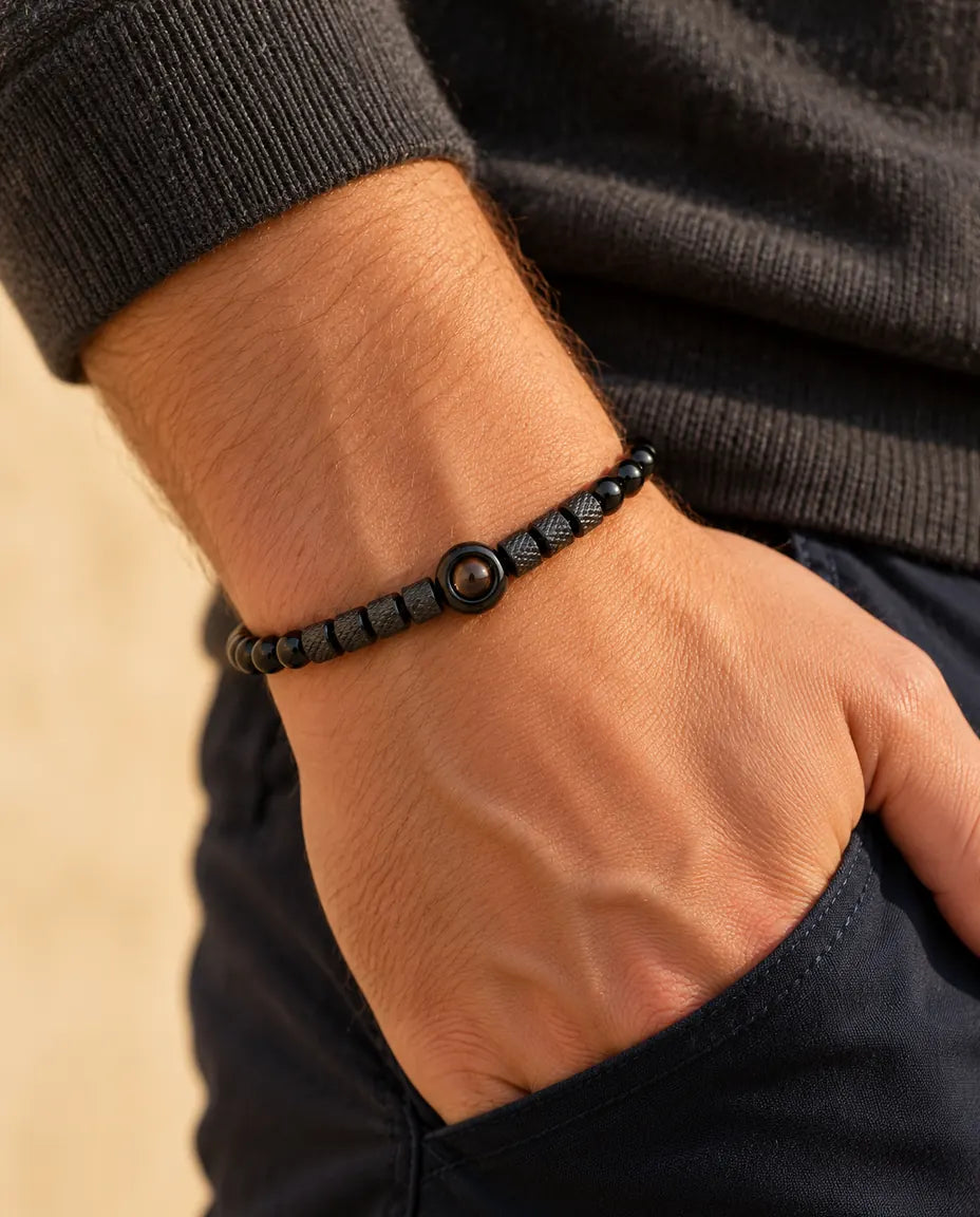 Man wearing the black photo projection bead bracelet, hand slipped into his pocket