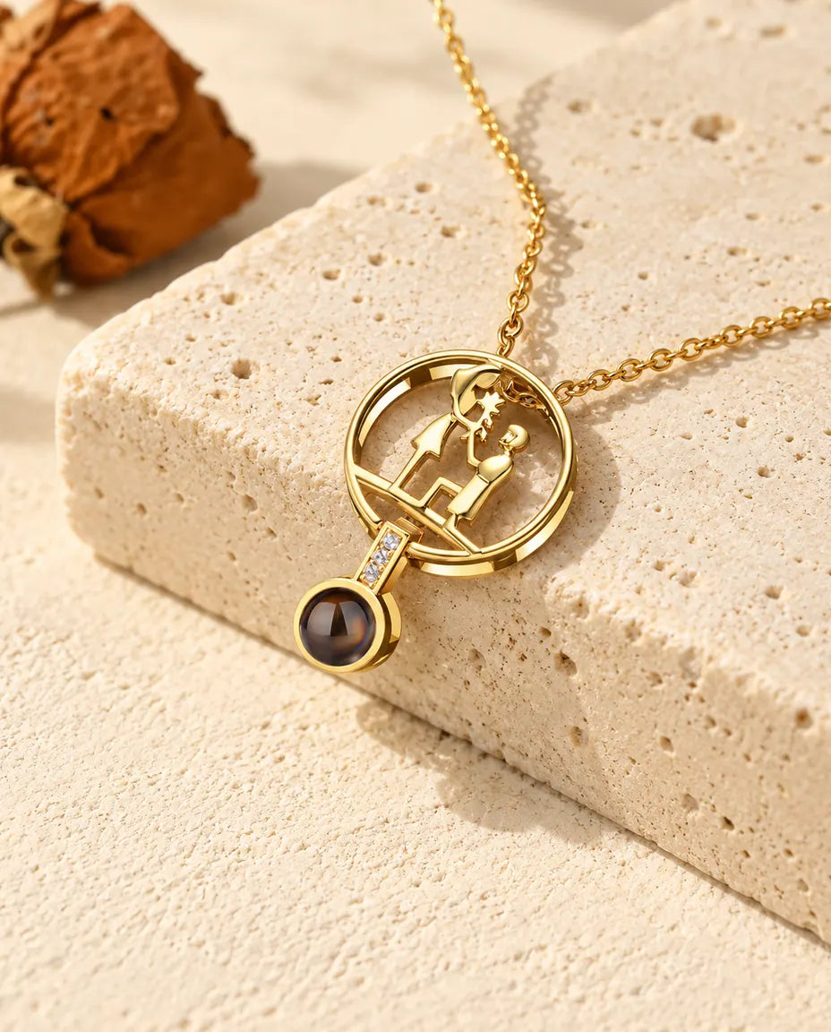 Personalized gold tone proposal photo projection necklace with a kneeling couple on travertine