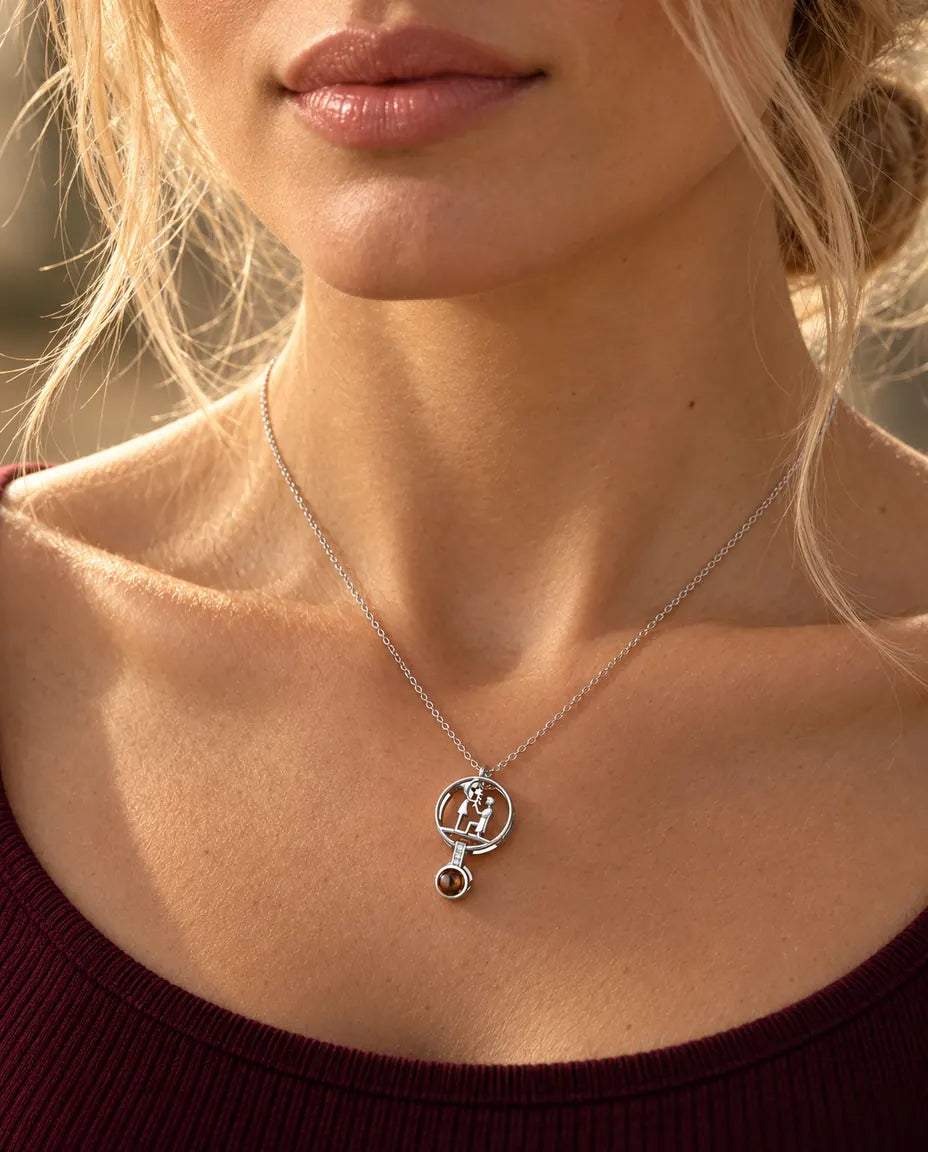 Woman in a burgundy top wearing the silver tone proposal projection necklace