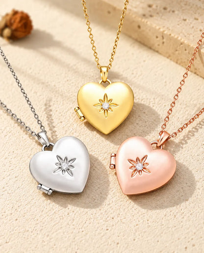 Three colors of the satin flower heart photo locket necklace arranged on plaster