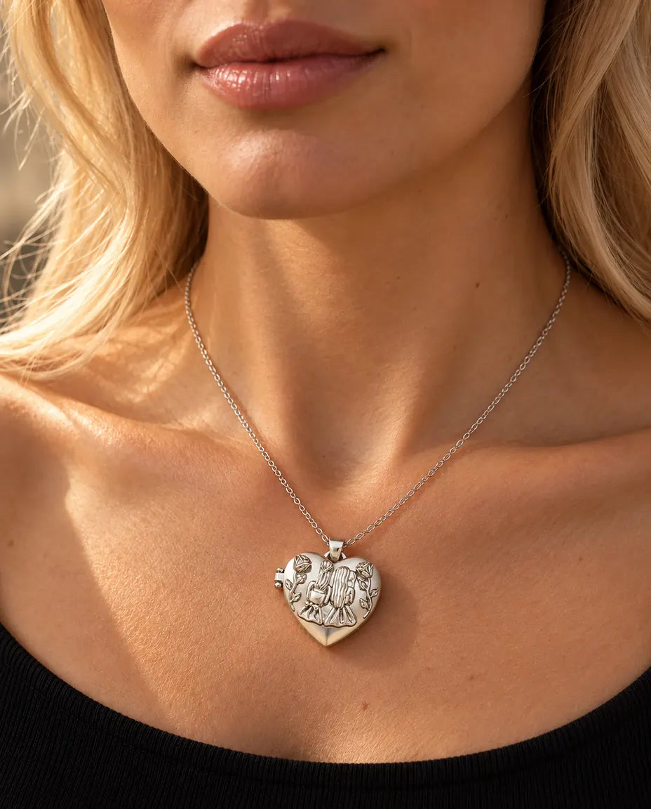 Woman in a black knit top wearing the silver tone sisters heart photo locket necklace