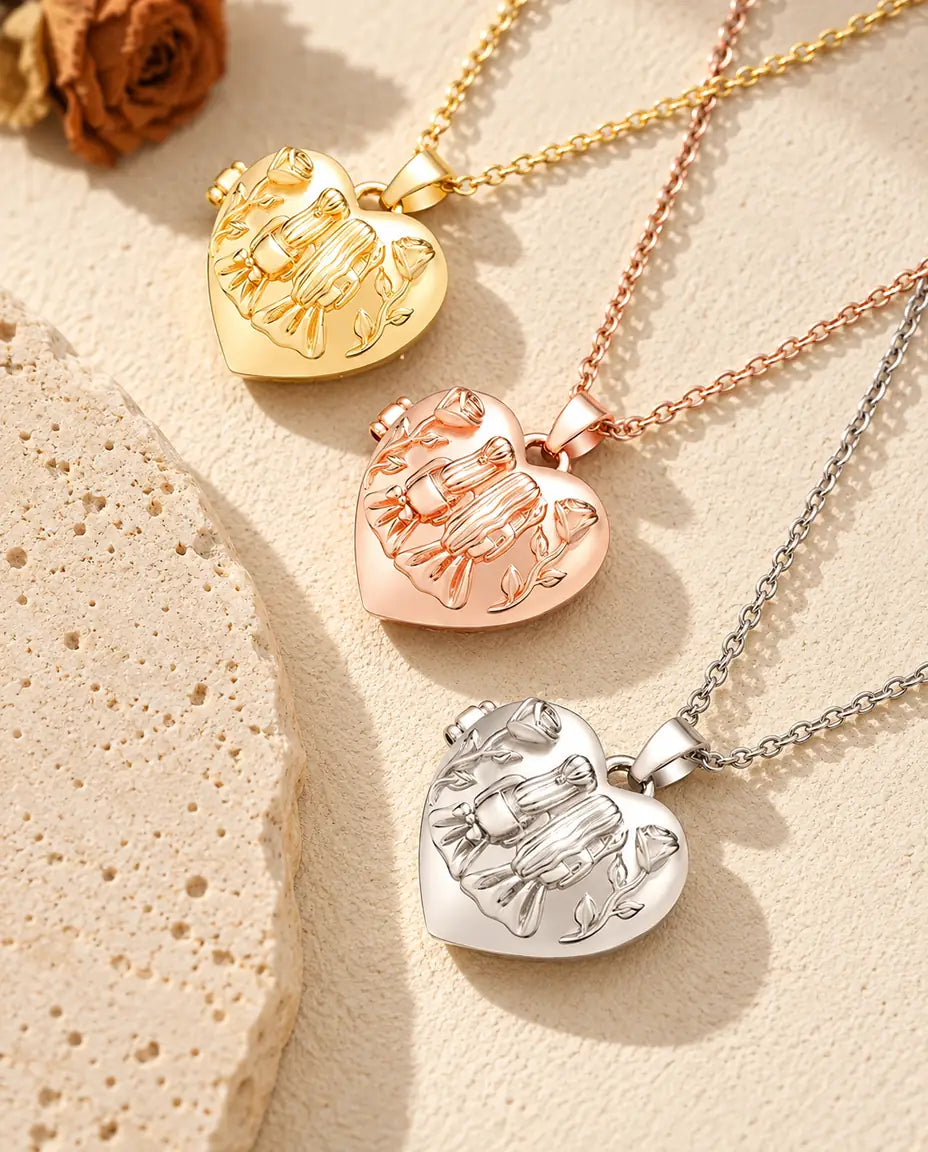 Gold tone, rose gold tone and silver tone sisters heart photo lockets stacked beside a travertine slab