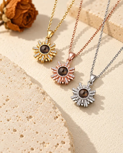 Gold tone, rose gold tone and silver tone sunburst pendants in a row
