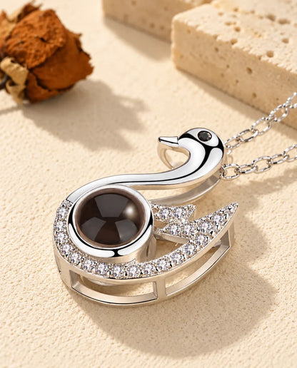 Close-up of the silver tone swan pendant with a cubic zirconia wing
