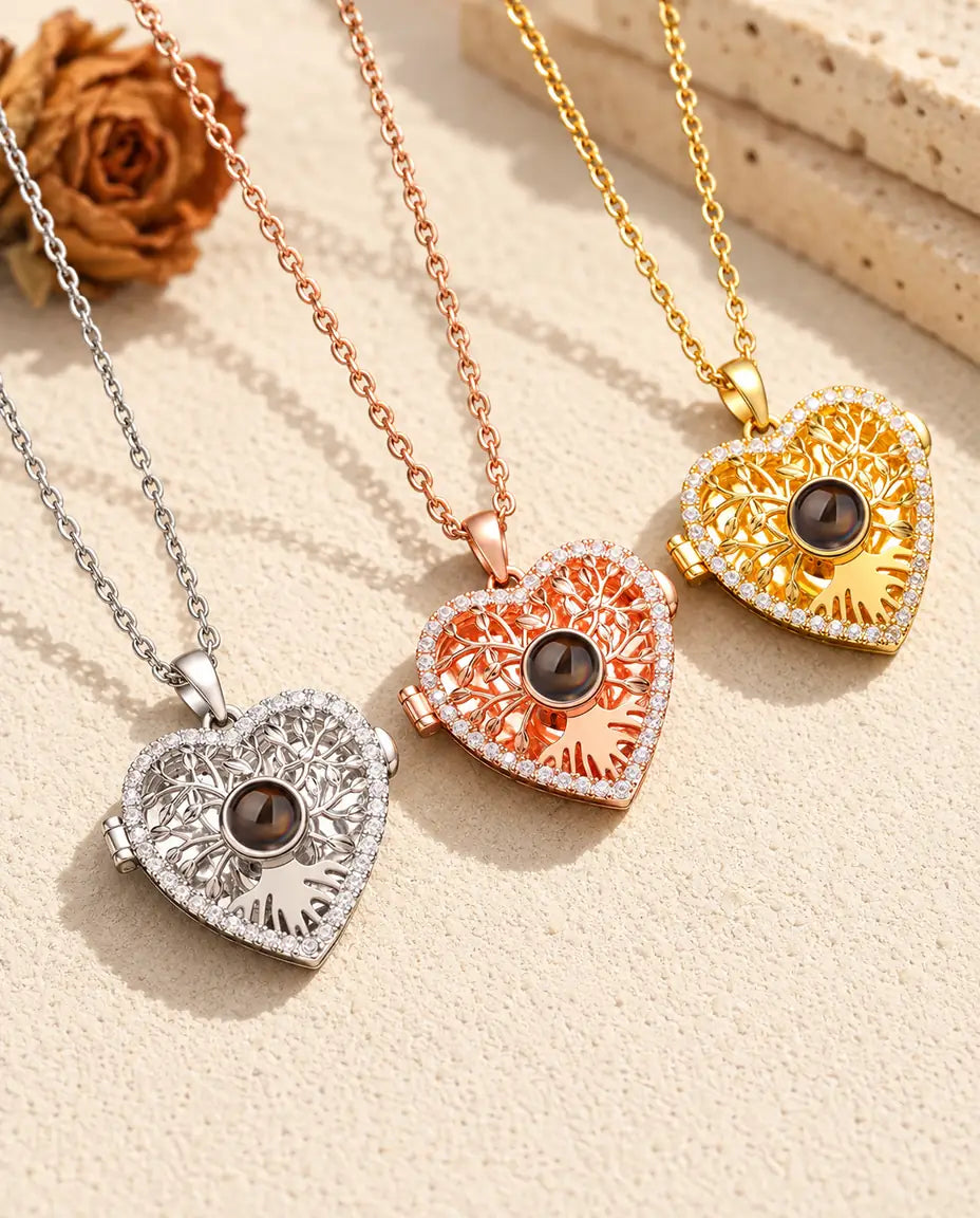 Three colors of the tree of life heart projection locket necklace side by side