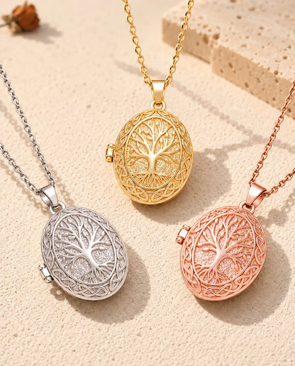 Three colors of the tree of life photo locket necklace arranged on plaster